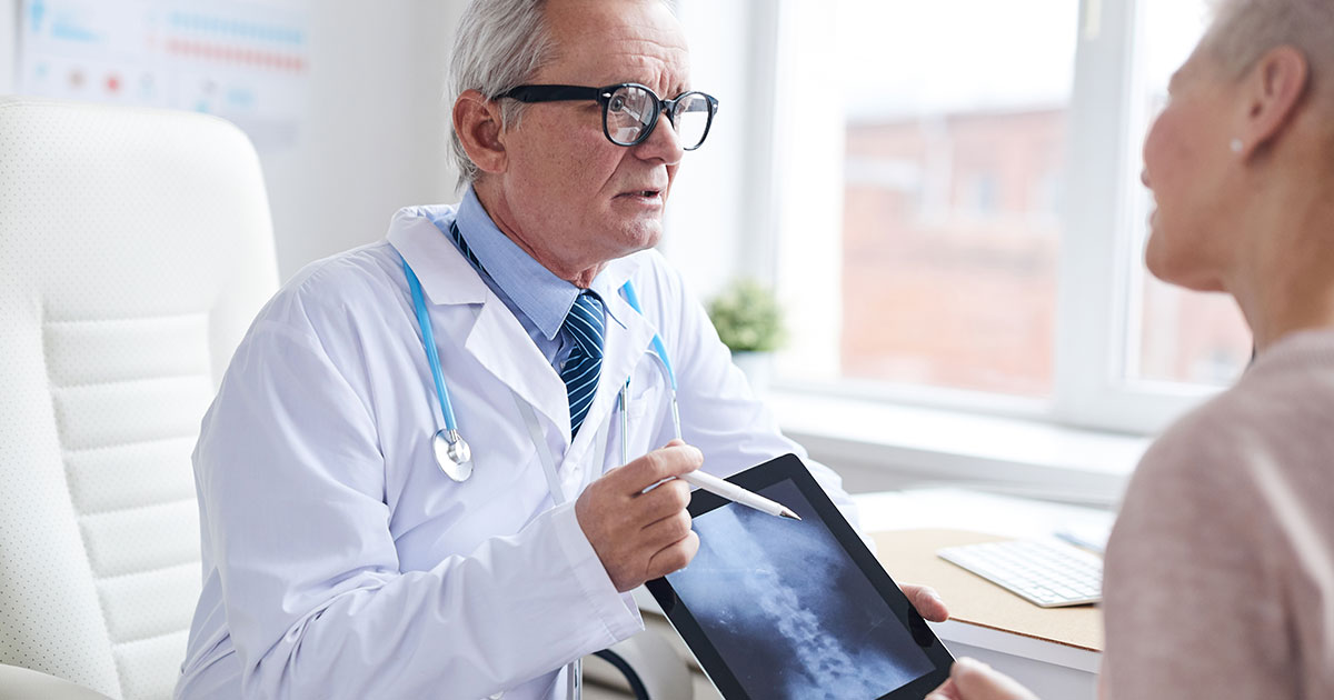 Doctor going over spinal cord injury with patient