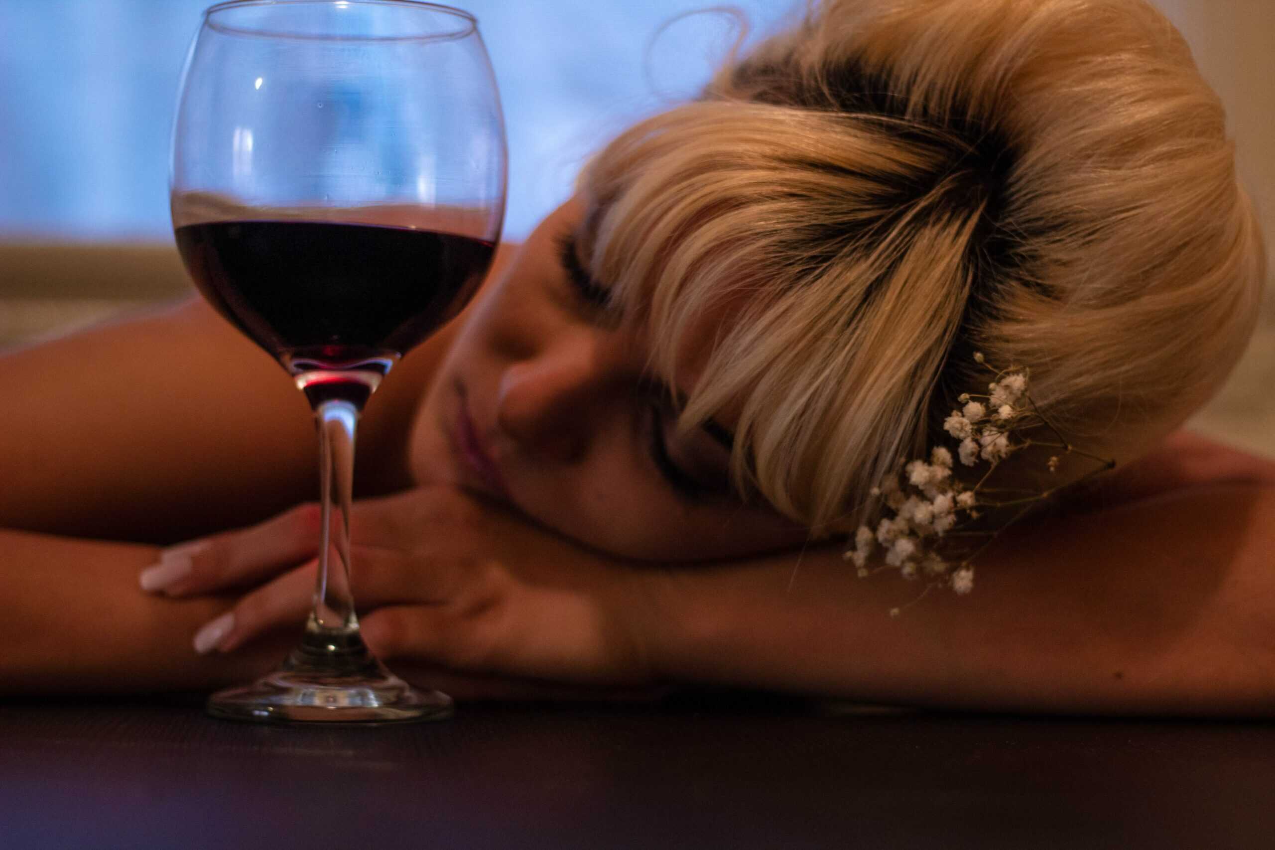 blonde by glass of wine passed out