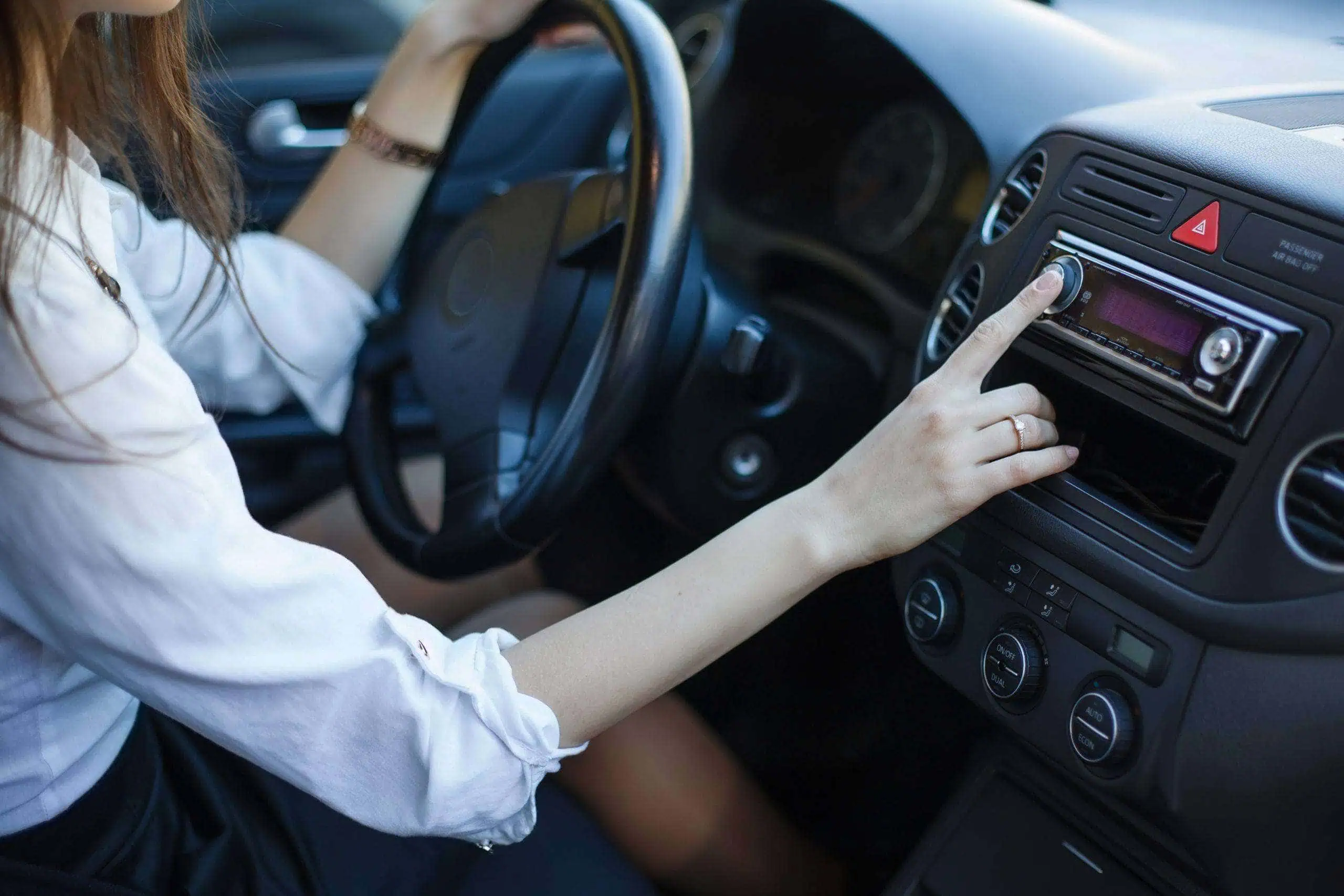 Woman turning up the music in her car