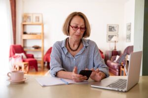 Older disabled woman working from home