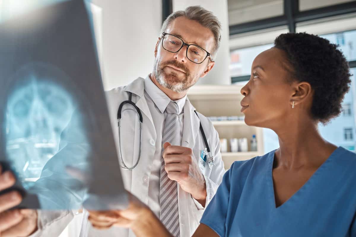 How is TBI Diagnosed? doctors looking at an x-ray of the brain