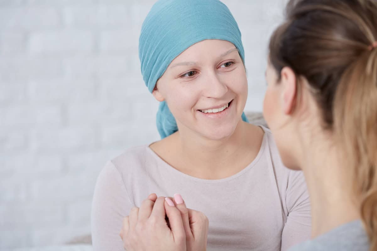 Physical Therapy woman with blue scarf around head going through physical therapy