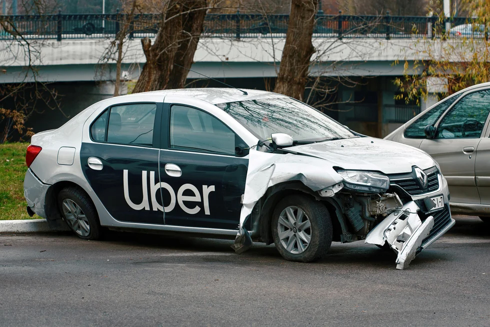 Silver colored uber car damaged