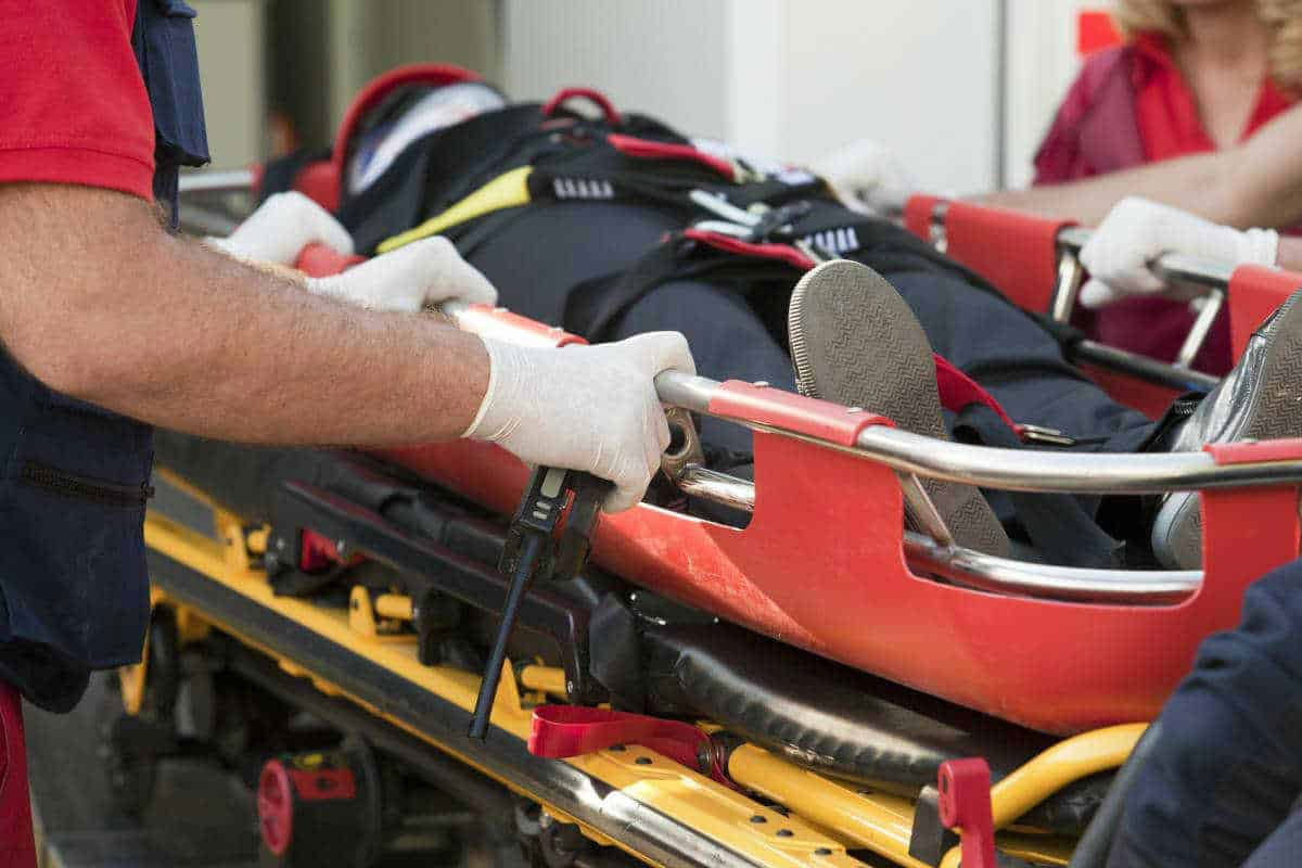 Man Being Cared For By Paramedics On A Stretcher