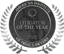 Black and white circular seal reading "American Institute of Trial Lawyers—Litigator of the Year" with laurel leaves surrounding the edge.