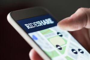A passenger looking at a rideshare app. What should I do when I’m a passenger in an Uber or Lyft accident?